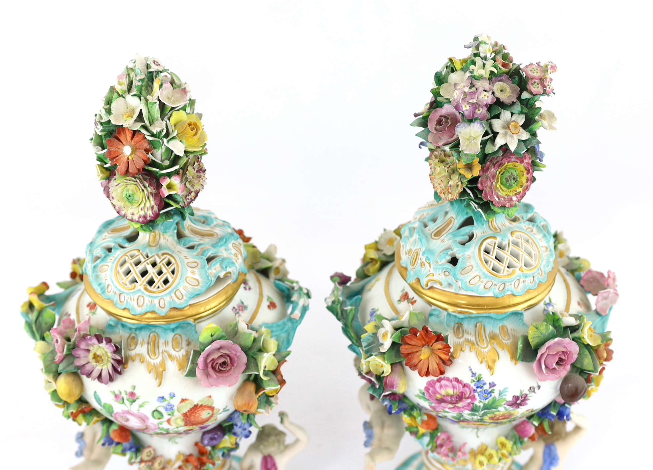 A pair of Meissen topographical flower encrusted vases and covers, 19th century, losses